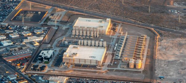 Aerial view of a large industrial manufacturing facility in a desert landscape, highlighting extensive infrastructure, water-intensive operations, and surrounding arid conditions underscoring resource constraints.
